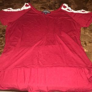 red shirt with white trimming on the shoulders